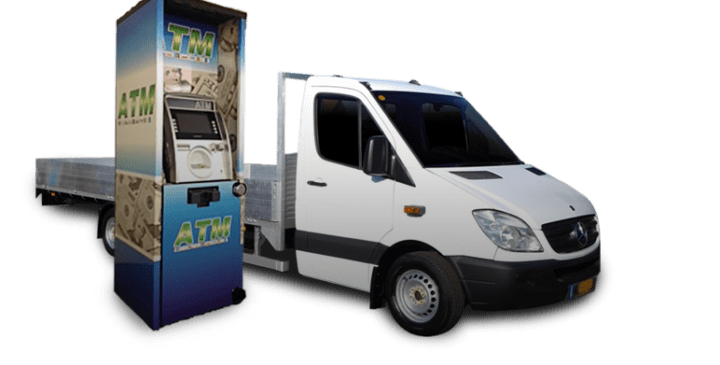 A delivery truck parked beside a brightly branded ATM, showcasing mobile banking solutions in an outdoor setting.